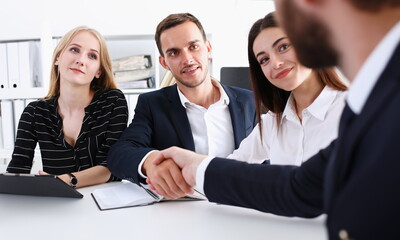 Wall Mural - Smiling man in suit shake hands as hello in office portrait. Friend welcome mediation offer positive introduction greet or thanks gesture summit participate approval strike arm bargain concept