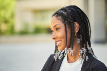 Smiling Stylish African American Woman Standing Against Blurred Background