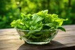 a clear glass bowl of green leafy veggies known for hormonal health
