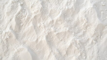Top view of white sand, captured in close-up detail, displaying textured grains.