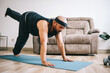 © Gatot - Funny fat bearded man in sportswear doing yoga or workout at home