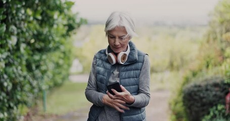 Wall Mural - Phone, fitness and senior woman at park outdoor on social media, reading email or sport notification. Smartphone, typing and serious elderly person scroll on mobile, app or communication to exercise