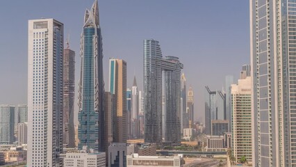 Wall Mural - Futuristic towers and skyscrapers with traffic on streets in Dubai Downtown and financial district during all day. Urban city skyline aerial timelapse with shadows moving fast until sunset