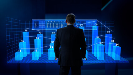 Fototapete - Business Analyst Working in Virtual Reality Office with Augmented Reality Screens. Manager Using a Virtual Touch Screen Hologram with Multiple Options, Generating Presentations With Graphs, Charts