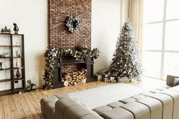 Christmas decorations in a beautiful and large Christmas room. The room and the room are decorated with festive decor. Christmas tree with gifts and fireplace.