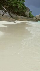 Wall Mural - landscape with white sand beach and storm sky on similan islands, thailand. vertical video