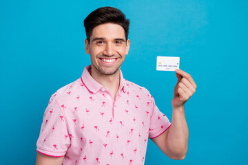 Sticker - Portrait of nice friendly man toothy smile arm hold showing debit plastic card isolated on blue color background