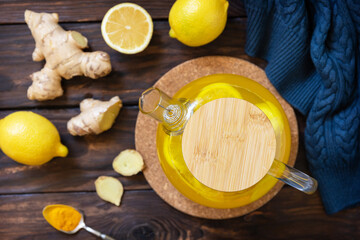 Wall Mural - Healthy turmeric hot drink tea with lemon, ginger and honey on rustic table. Alternative medicine concept, immune system booster in winter. View from above.