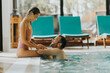 © BGStock72 - Young couple relaxing in the indoor swimming pool
