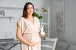 © Pixel-Shot - Young pregnant woman with baby toy at home