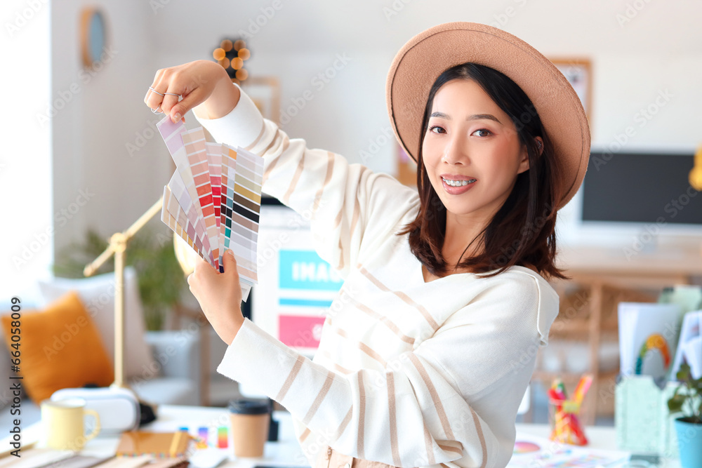 Asian interior designer with color palettes in office