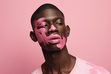 Canvas Print - A dark-skinned young man with his face smeared with pink paint