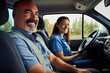 © Konstiantyn Zapylaie - Instructor and student both wear smiles inside the car during driving lessons for adults