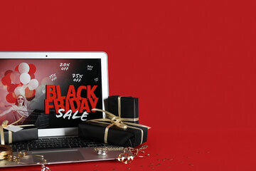 Sticker - Laptop with Black Friday fashion sale advertisement, jewellery and gift boxes on red background