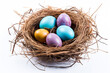 © JLabrador - Festive Nest: Colorful Eggs on a White Isolated Background
