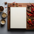 Plain book cover surrounded by food ingredients from chilli and spice are arranged in a border.