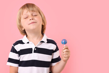 Wall Mural - Cute little boy with lollipop on pink background, space for text