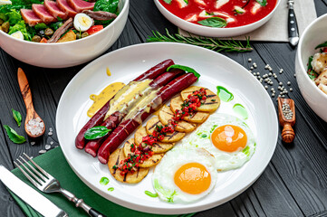 Sticker - Assorted food set on table, tomato soup with mozzarella, tuna salad, scrambled eggs with sausages