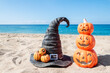 Halloween beach background with pumpkins and witch hat
