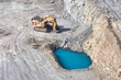 open pit diamond mine, Surface mining hydraulic excavator dinging in the pit, surface water infiltration