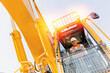 © Parilov - Industry worker portrait. Man driver builder operate crane or excavator at construction site