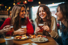 Three Young Women Enjoying A Leisurely Breakfast Together, Raising Their Glasses Of Beer In A Toast, Share Laughter And Conversation, Celebrating Their Friendship Over A Casual And Fun Meal