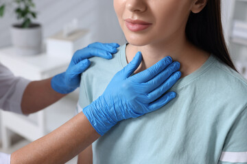 Wall Mural - Endocrinologist examining thyroid gland of patient indoors, closeup