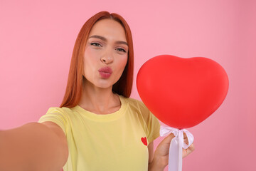 Sticker - Beautiful woman with red heart shaped balloon taking selfie and sending air kiss on pink background