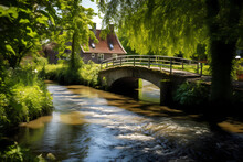 Footbridge Over Canal Or Stream, Creek Or Brook With Serene Sun Dappled Beautiful Homes, Gardens And Trees