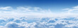 Panorama of blue sky and soft white cumulus clouds in the summer sun as a background. Copy space