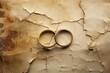 cracked wedding rings lying on an antique parchment