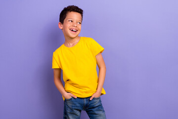 Poster - Photo of glad joyful boy wear yellow stylish clothes hands in pockets look special news empty space isolated on purple color background