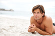 © Marine Gastineau/peopleimages.com - Man, beach and sand for relax stomach for vacation sunshine holiday, summer break or tropical travel. Male person, topless and ocean fresh breeze for happy outdoor weekend, swimwear rest or sea water