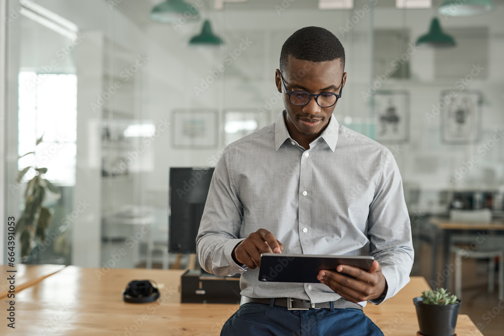 African businessman working on a tablet in a modern office Stock Photo ...