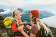 Mother traveling with daughter child family happy laughing together outdoor hiking in Norway healthy lifestyle backpacking in mountains active vacations woman with kid Mother's day holiday