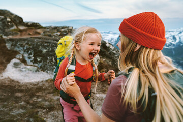 Wall Mural - Family Mother traveling with daughter child having fun outdoor hiking together happy emotions active vacations in mountains 4 years old kid girl laughing