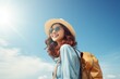 Happy young Asian tourist woman wearing beach hat, sunglasses and backpacks going to travel on holidays on blue background.