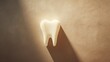 Human tooth against stone beige background with shadow cast by strong light, represents simplicity maintaining healthy teeth, child milk tooth, minimalistic dental care concept