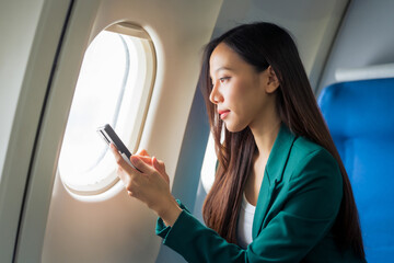 Female airplane passengers asian chinese people Entrepreneurs on Flight, Venturing Overseas Investments. Global Business Expansion, Foreign Markets, Strategic Financial Moves. Women in Business Suits