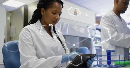 Canvas Print - Animation of medical data processing on african american female scientist using tablet at laboratory