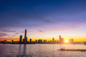 Wall Mural - Seoul city Skyscrapers at night along the Hangang River after sunset at twilight and the sky with beautiful colors at yeouido, south Korea.