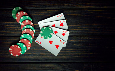 Popular poker game. Playing cards with a winning combination of two pairs on a black table in a poker club. Winning in sports depends on luck