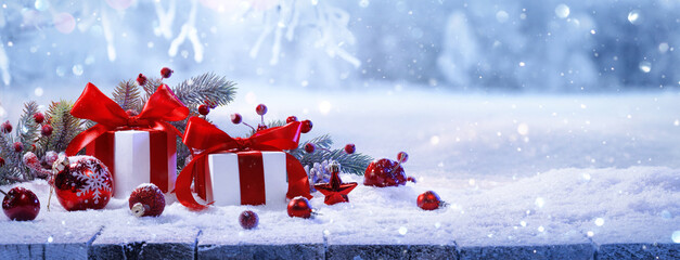 Poster - Christmas Gifts With Red Bows On A Winter Forest Background