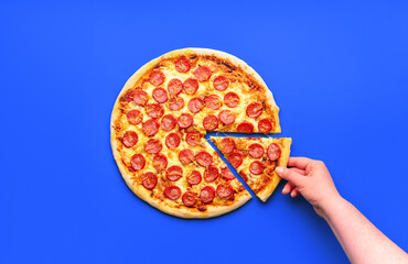 Wall Mural - Homemade pizza pepperoni isolated on a blue background