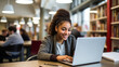 © Tammy-MLA - Portrait of a smiling african american college student or workplace using laptop in library