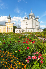 Wall Mural - Decorative flowers against the background of the Orthodox church in the Khutynsky monastery in Veliky Novgorod, Russia. Selective focus