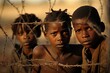 African refugees kids in front of barbed wire border.