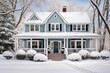 Colonial house with side porches covered in snow.