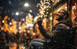 Young disabled man in a wheelchair is happy and smiling on the street during a festive Christmas evening.
