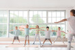 © Pixel-Shot - Group of little children practicing yoga with instructor in gym